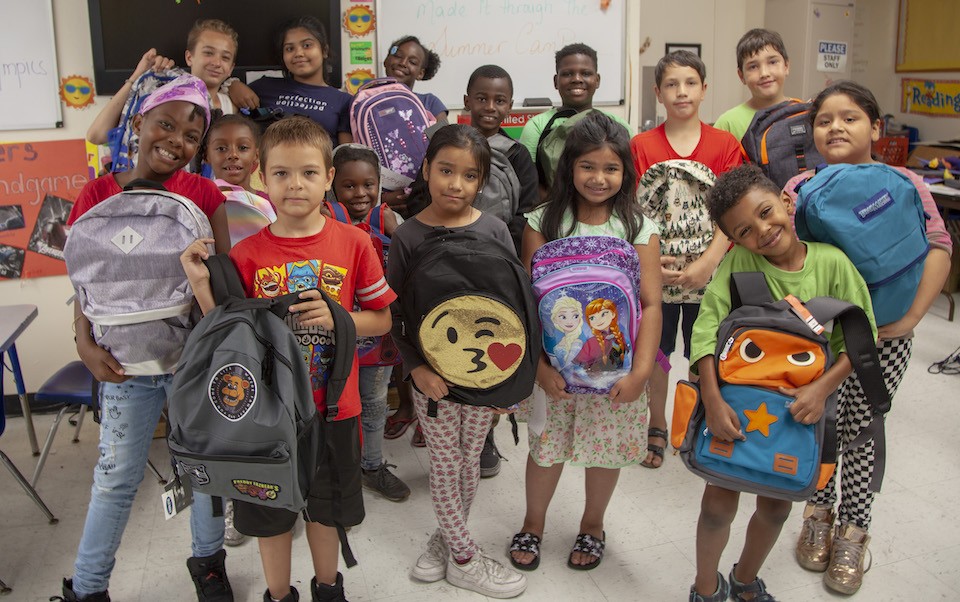 Kids posing with backpacks