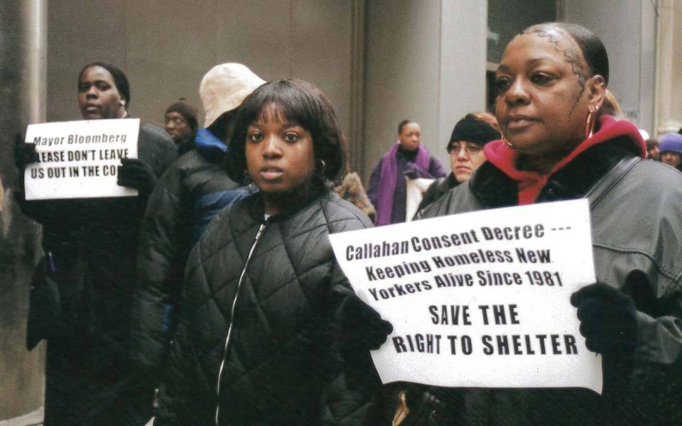 A group of adults marching with a sign that reads "Callahan Consent Decree... Keeping Homeless New Yorkers Alive Since 1981. Save the Right to Shelter."