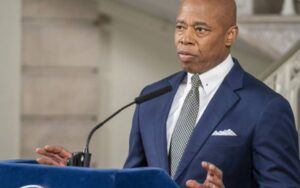 Mayor Eric Adams wearing a blue suit.
