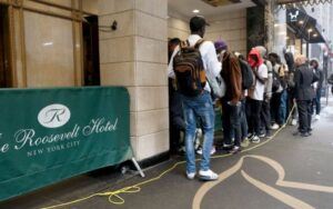 Dozens of recently arrived African migrants are pictured outside the Roosevelt Hotel early on Sept. 26 Luiz C. Ribeiro—NY Daily News/Getty Images