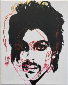 White background with a black print of Prince's face with a red outline slightly to the left.