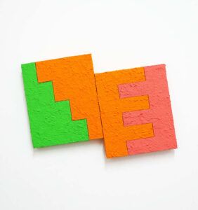 Two squares touching each other with green, orange, and pink designs