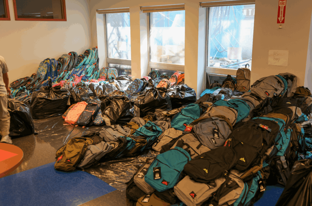 Backpacks stacked up in preparation for Project: Back to School